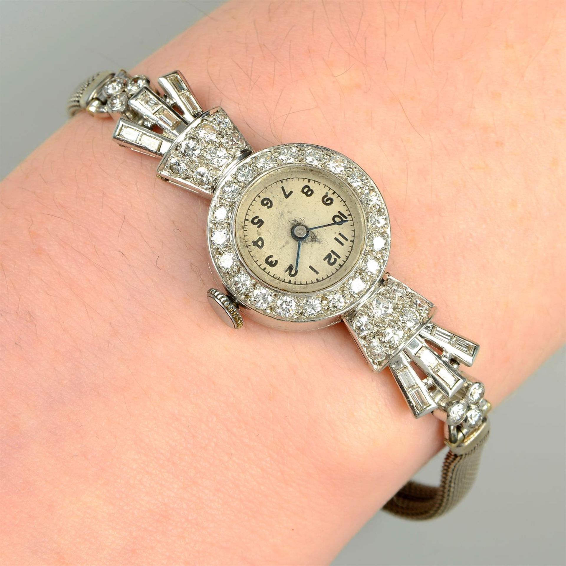 A mid 20th century platinum vari-cut diamond cocktail watch, on 9ct gold bracelet.