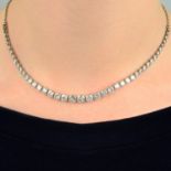 A graduated circular-cut diamond collet necklace, with trace-link back-chain.