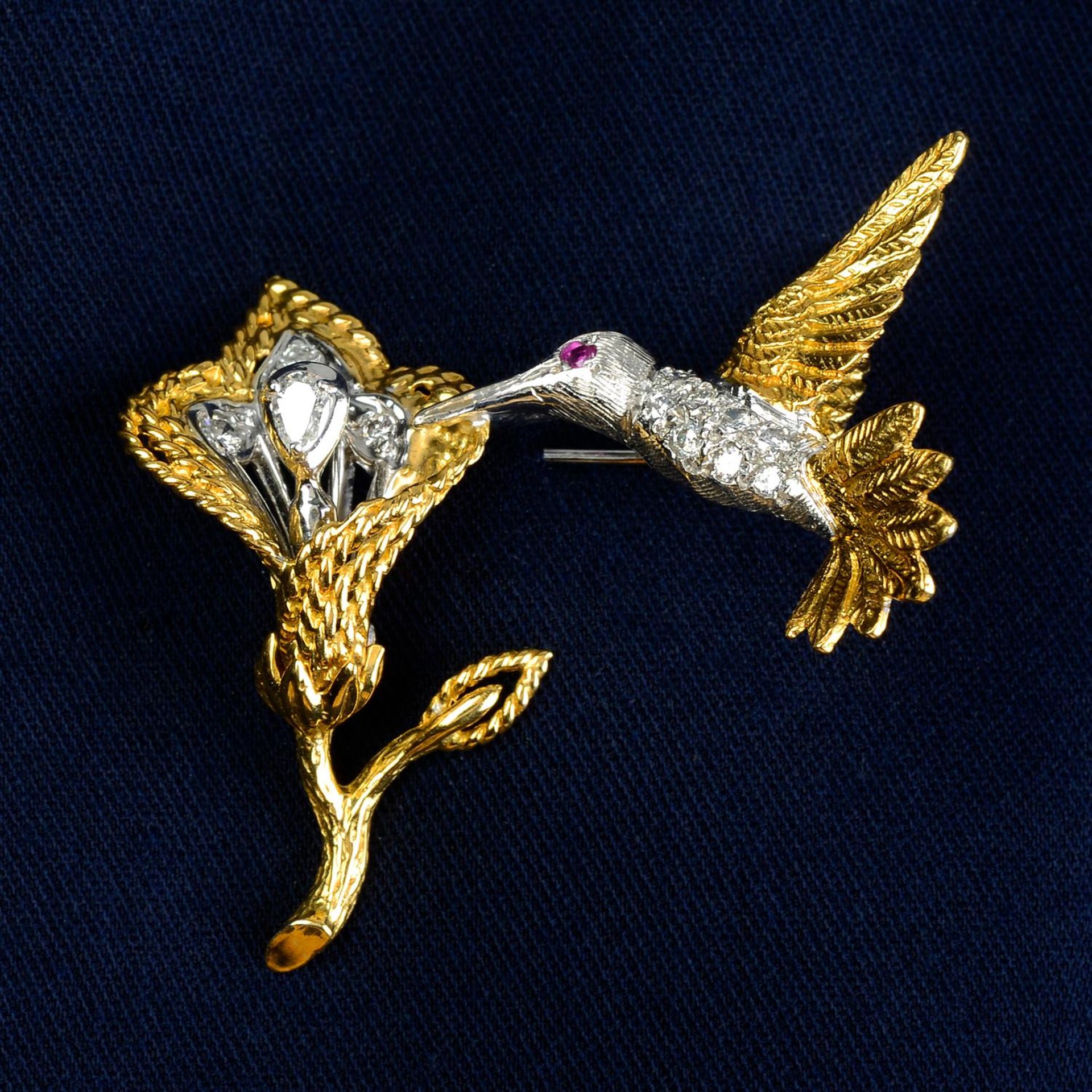 A diamond bird brooch, with tremblant flower.
