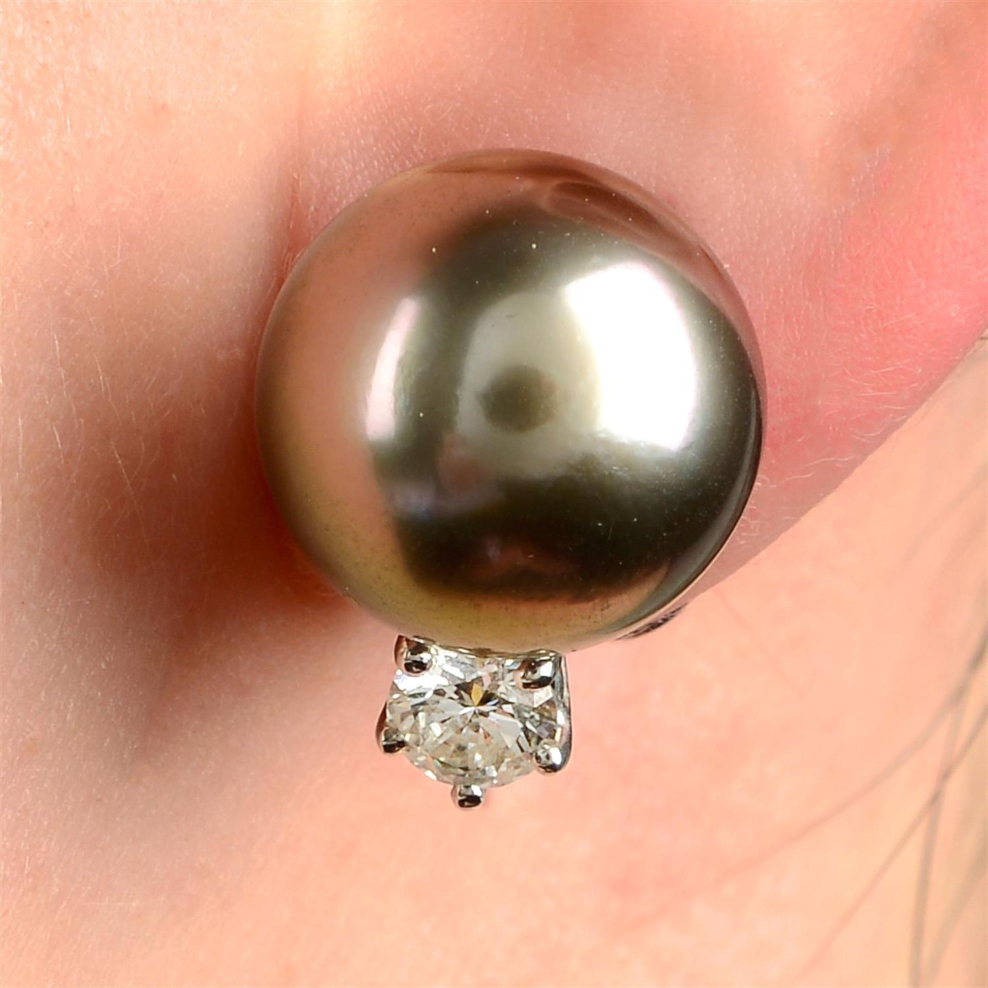 A pair of brilliant-cut diamond highlight 'Tahitian' cultured pearl stud earrings.