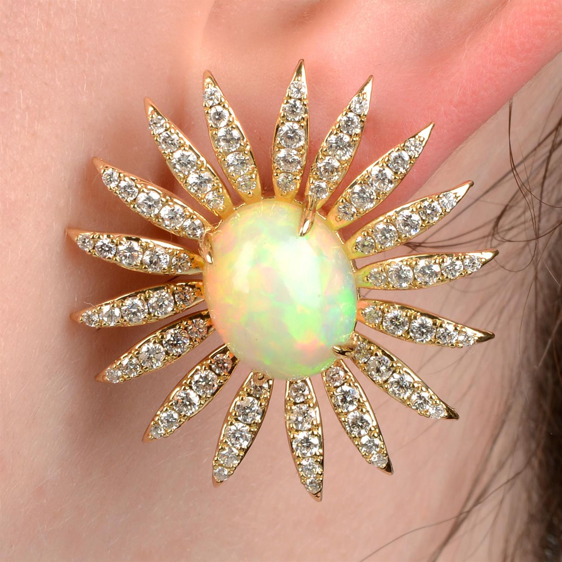 A pair of opal and brilliant-cut diamond floral earrings.