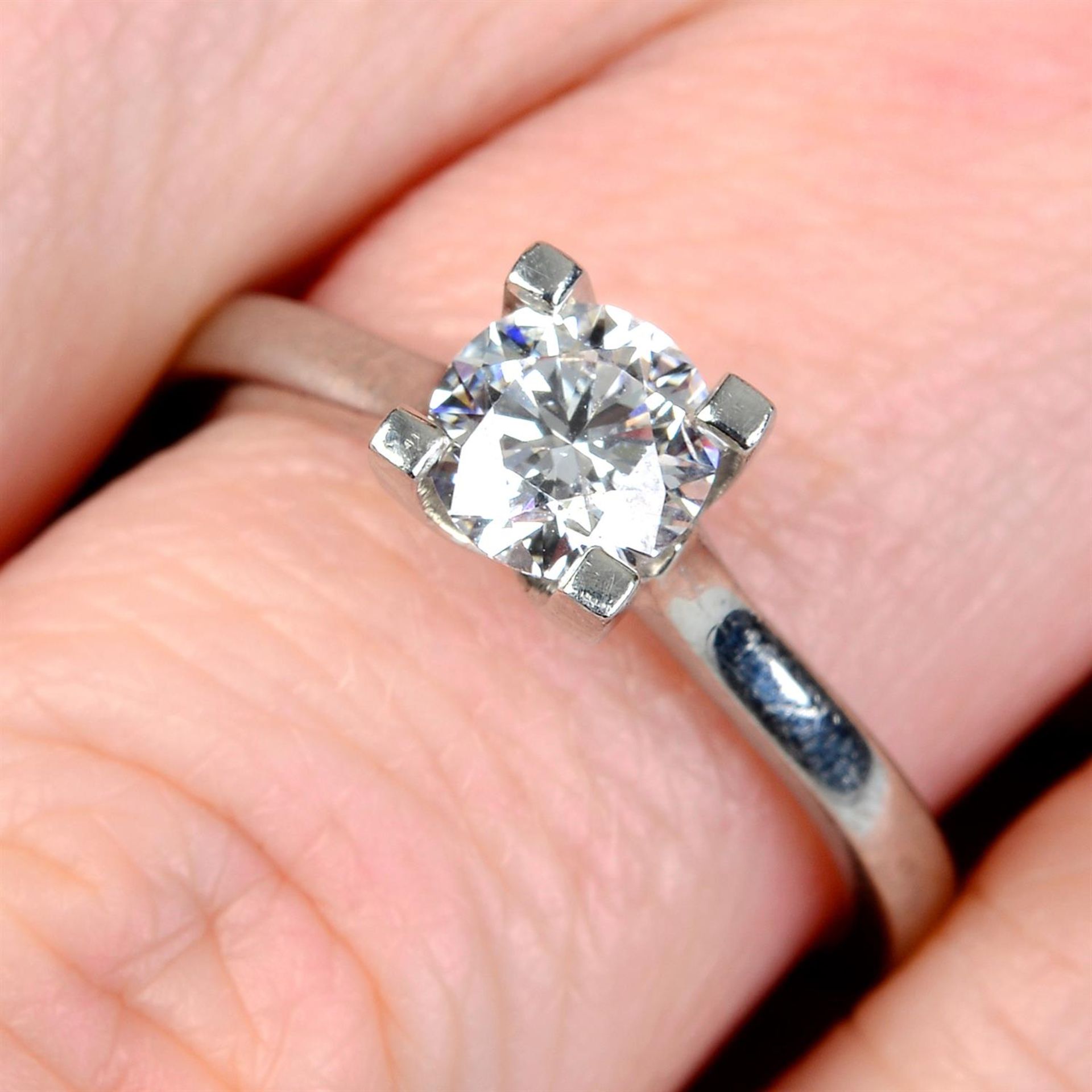 A platinum brilliant-cut diamond single-stone ring.