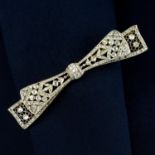 An early 20th century platinum and 18ct gold, old and rose-cut diamond openwork bow brooch.