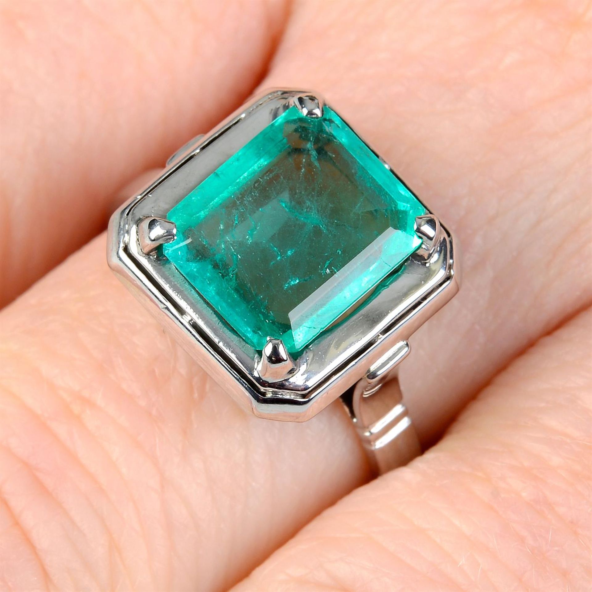 An emerald single-stone ring.