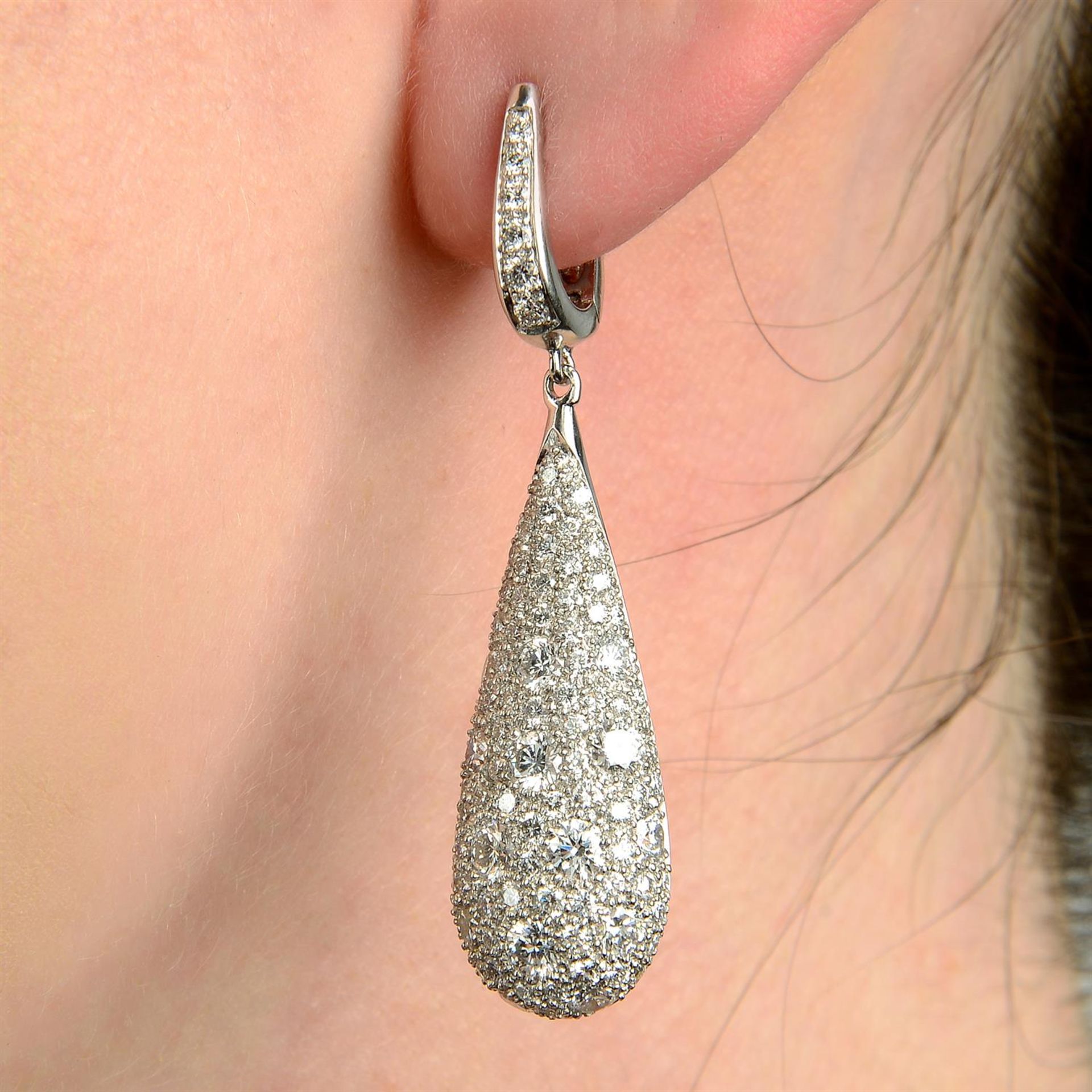A pair of pavé-set diamond drop earrings.