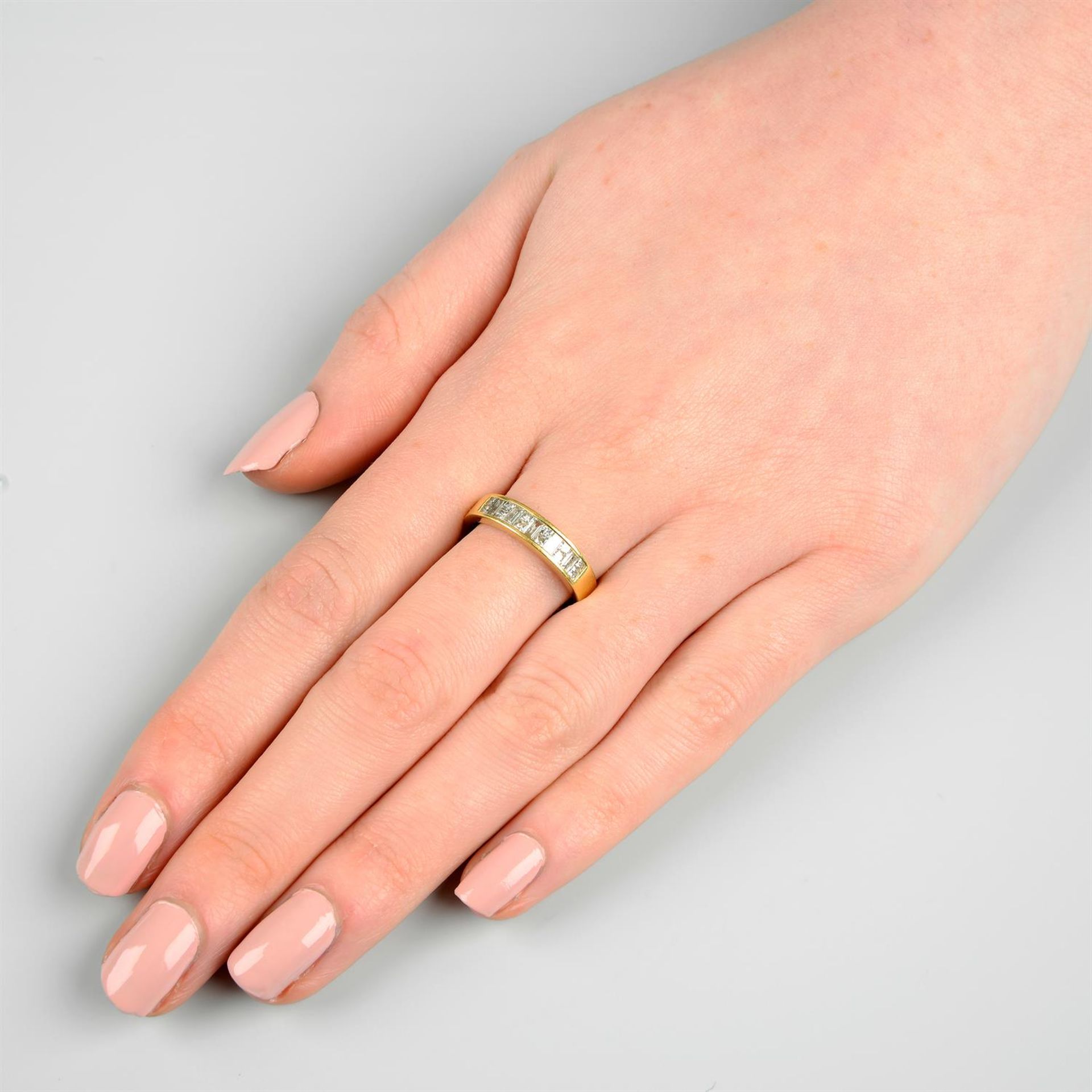 An 18ct gold baguette-cut and square-shape diamond half-eternity ring. - Image 6 of 6