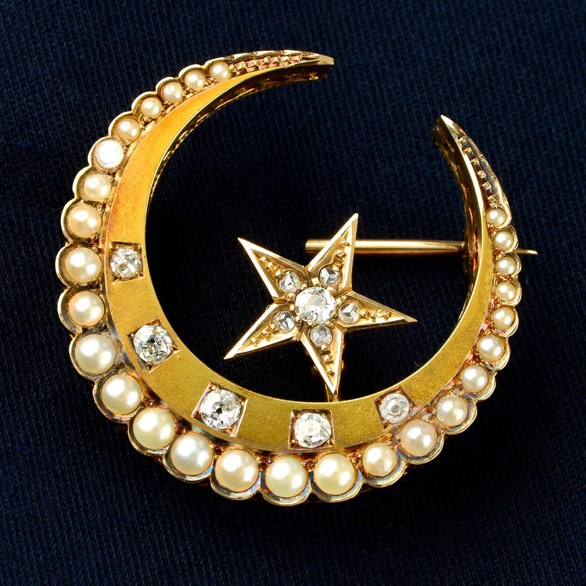 A late Victorian gold split pearl and diamond star and crescent moon brooch.
