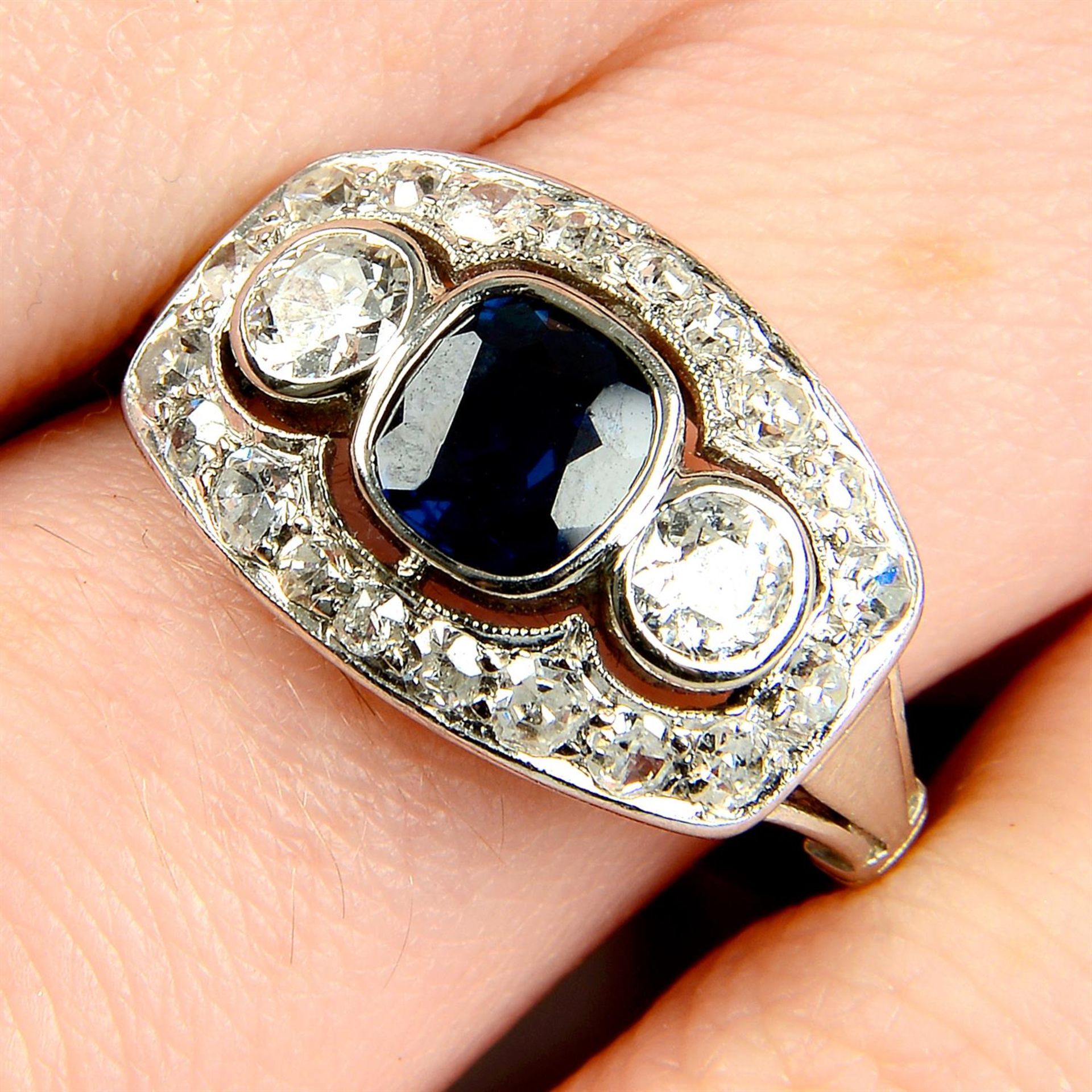 A sapphire, circular and single-cut diamond dress ring.