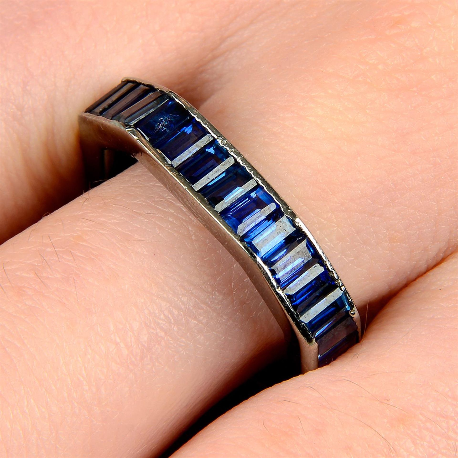 A rectangular-shape sapphire octagonal-shape full eternity ring.