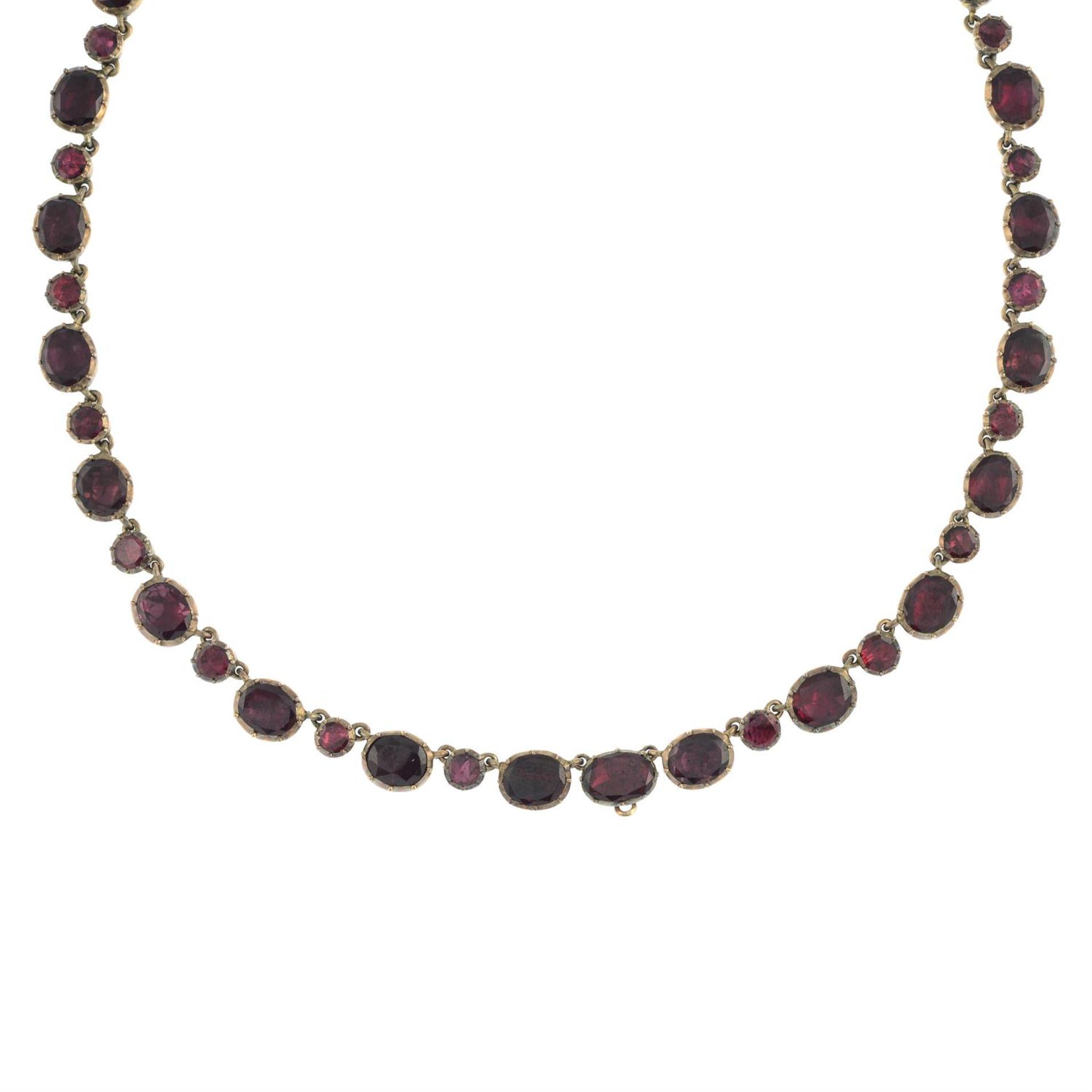A late Georgian gold foil back garnet rivière necklace. - Image 2 of 5