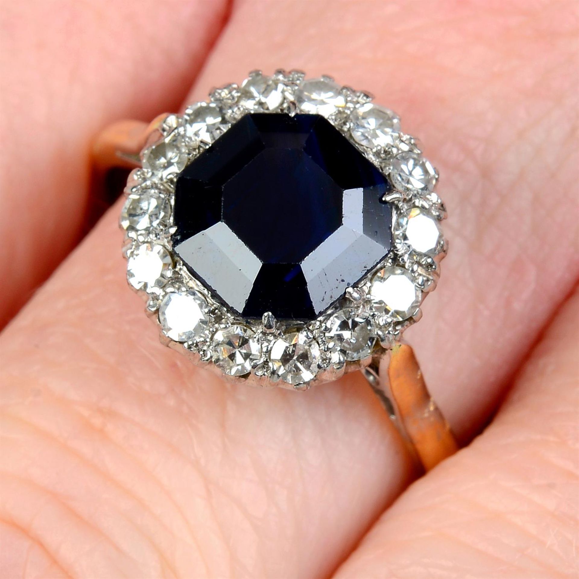 A mid 20th century platinum and 18ct gold sapphire and single-cut diamond cluster ring.