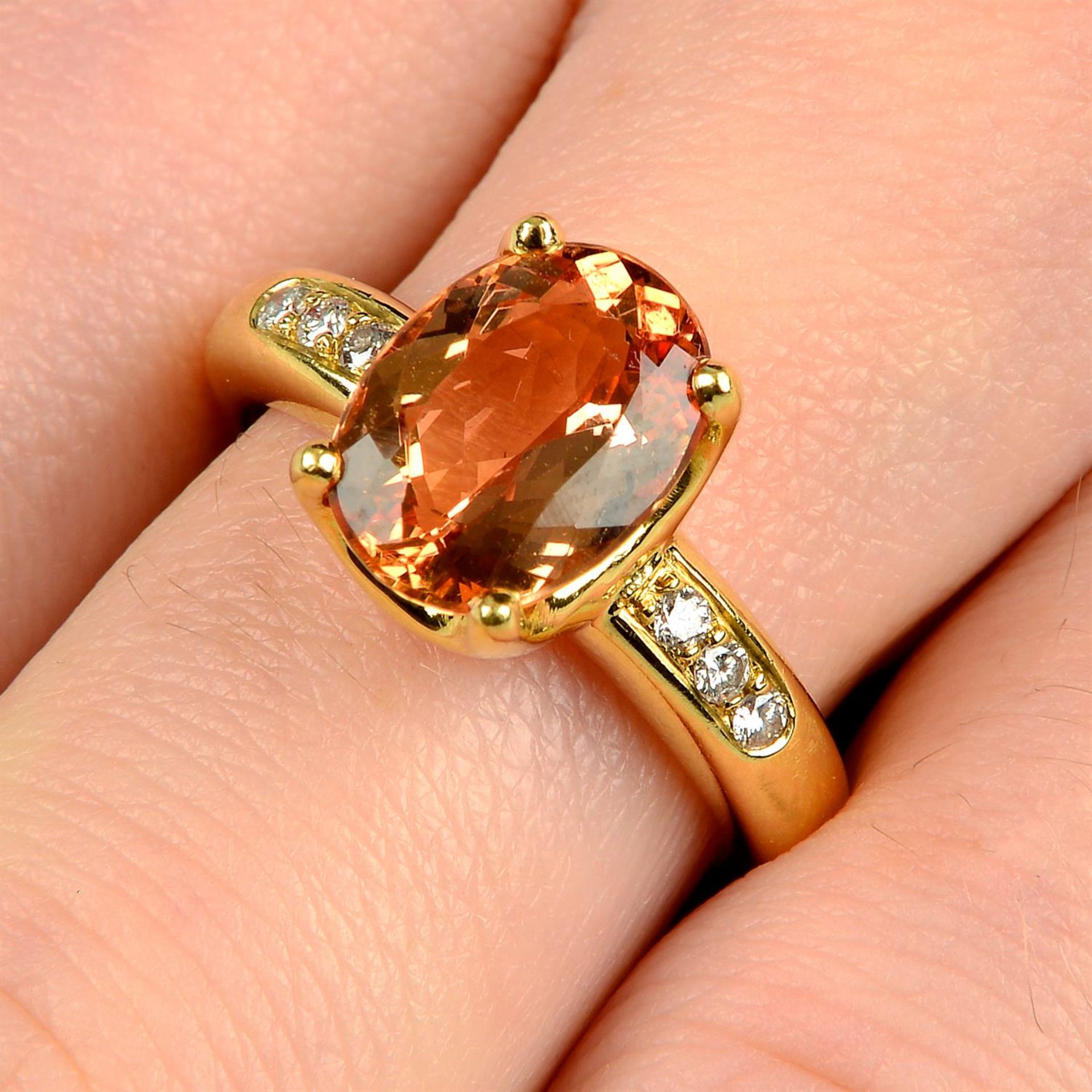 An orange topaz ring, with brilliant-cut diamond line shoulders, by H. Stern.