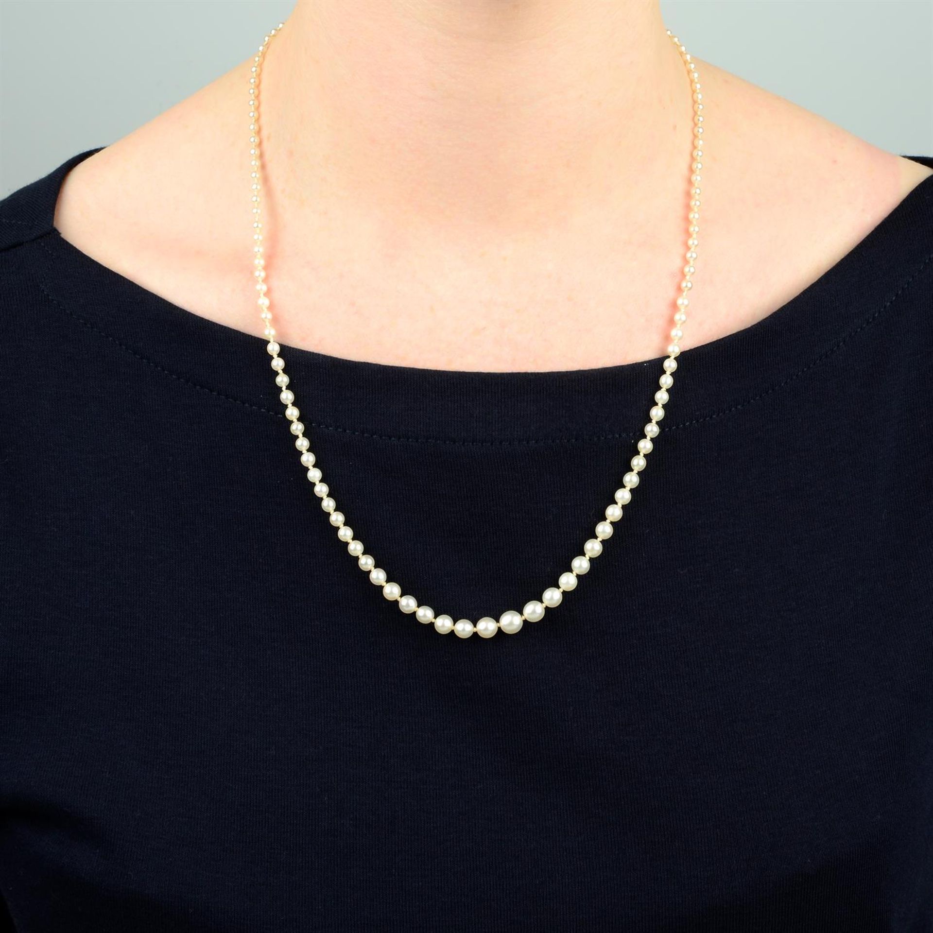 An early 20th century graduated pearl single-strand necklace, with sapphire cabochon and single-cut - Image 5 of 5