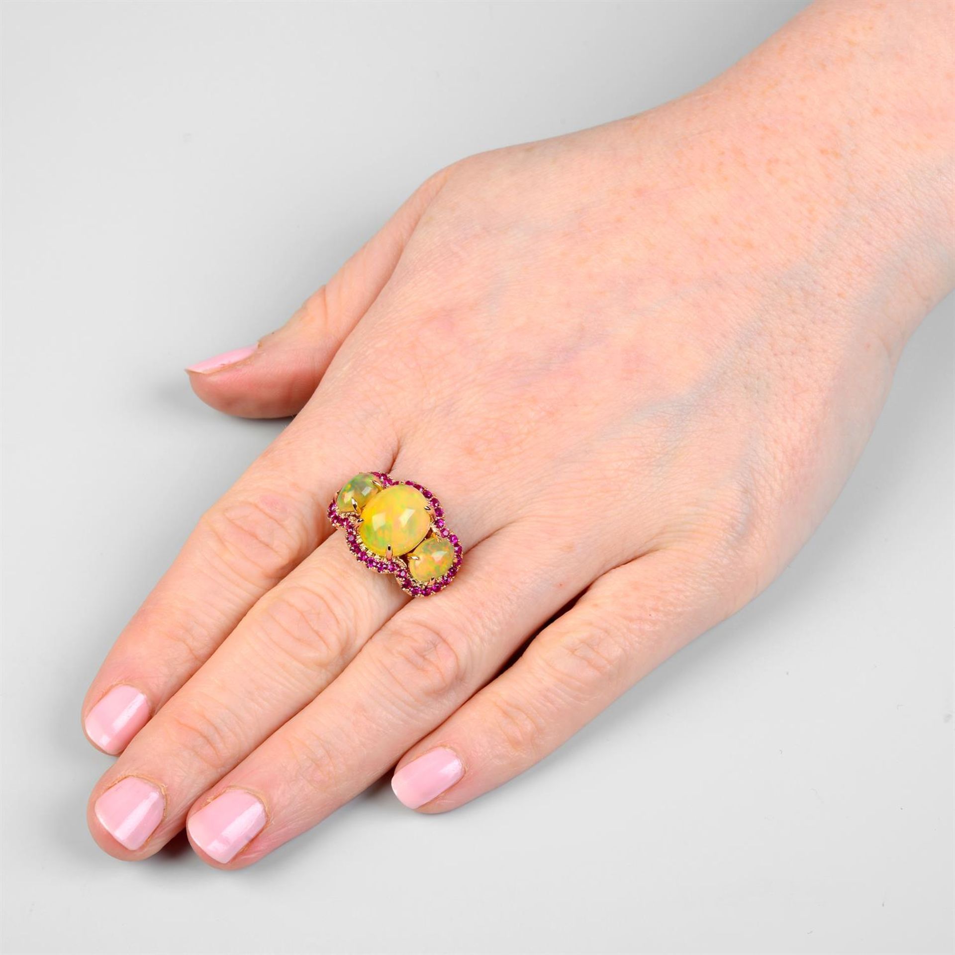 A graduated opal three-stone ring, with ruby shared surround. - Bild 6 aus 6