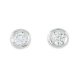 A pair of diamond single-stone stud earrings.