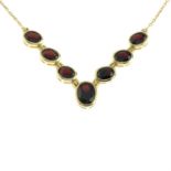 An oval-shape garnet necklace.