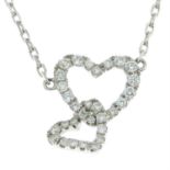 A pave-set diamond double heart pendant, with integral trace-link chain.