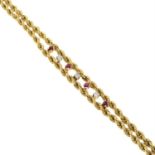 A diamond and ruby accent rope-twist link bracelet.