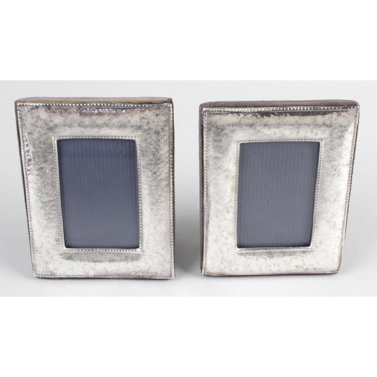 A pair of modern silver mounted small photograph frames of rectangular outline.