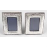 A pair of modern silver mounted small photograph frames of rectangular outline.