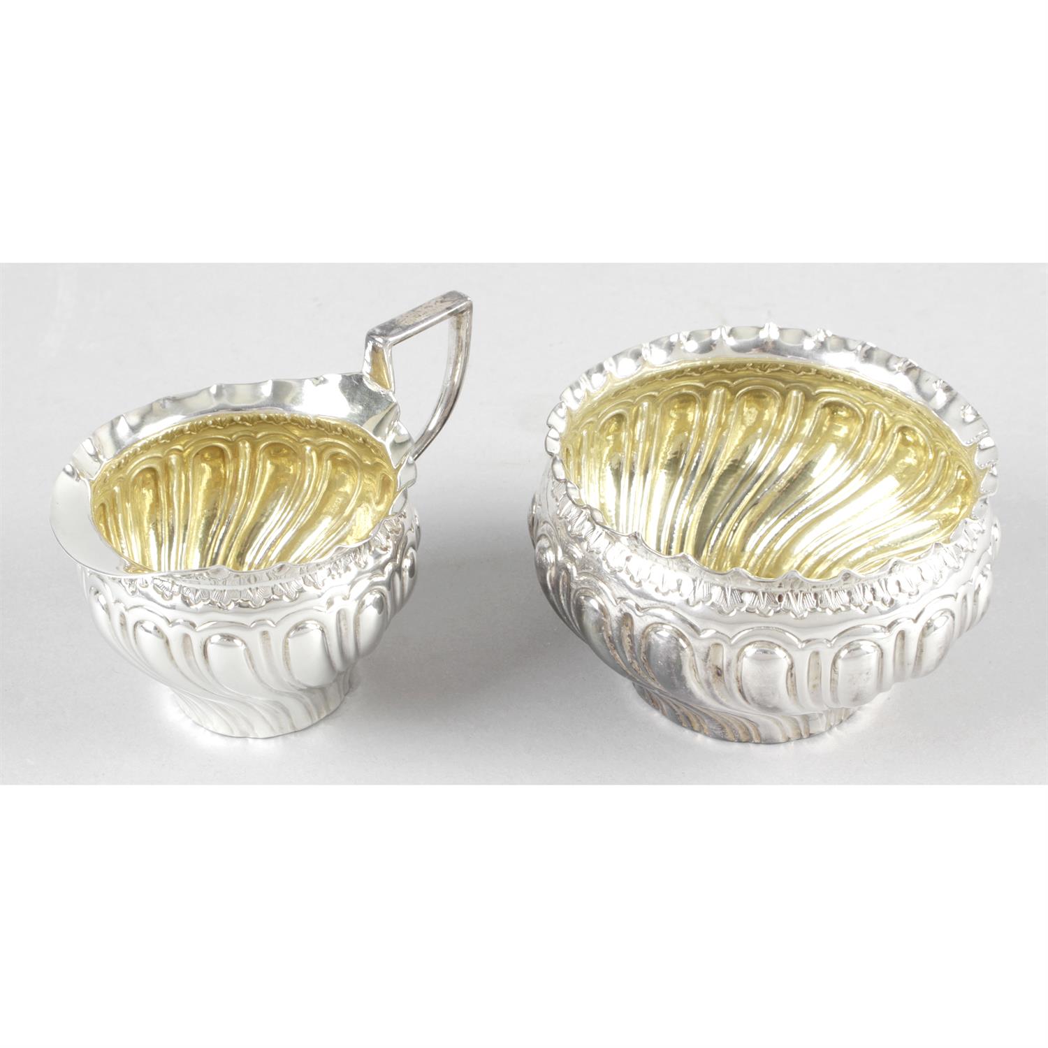 A late Victorian silver sugar bowl and matching cream jug.