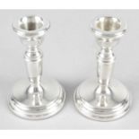 A pair of modern silver mounted small candlesticks.