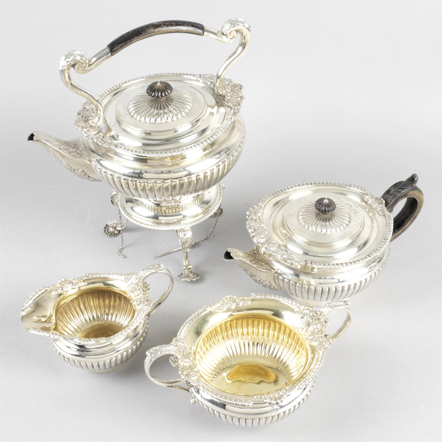A late Victorian silver part tea service with spirit kettle on stand.