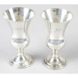 A pair of modern silver small goblets, together with a child's pusher and spoon set in fitted case.