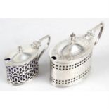 A Victorian silver mustard pot, together with a smaller example. (2).