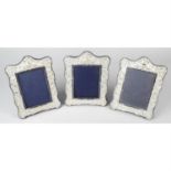 A matched set of three modern silver mounted photograph frames. (3).