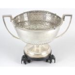 A late Victorian silver twin-handled rose bowl, on hardwood stand.