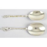 Two early George V silver-gilt spoons with figural terminals, together with a French silver spoon