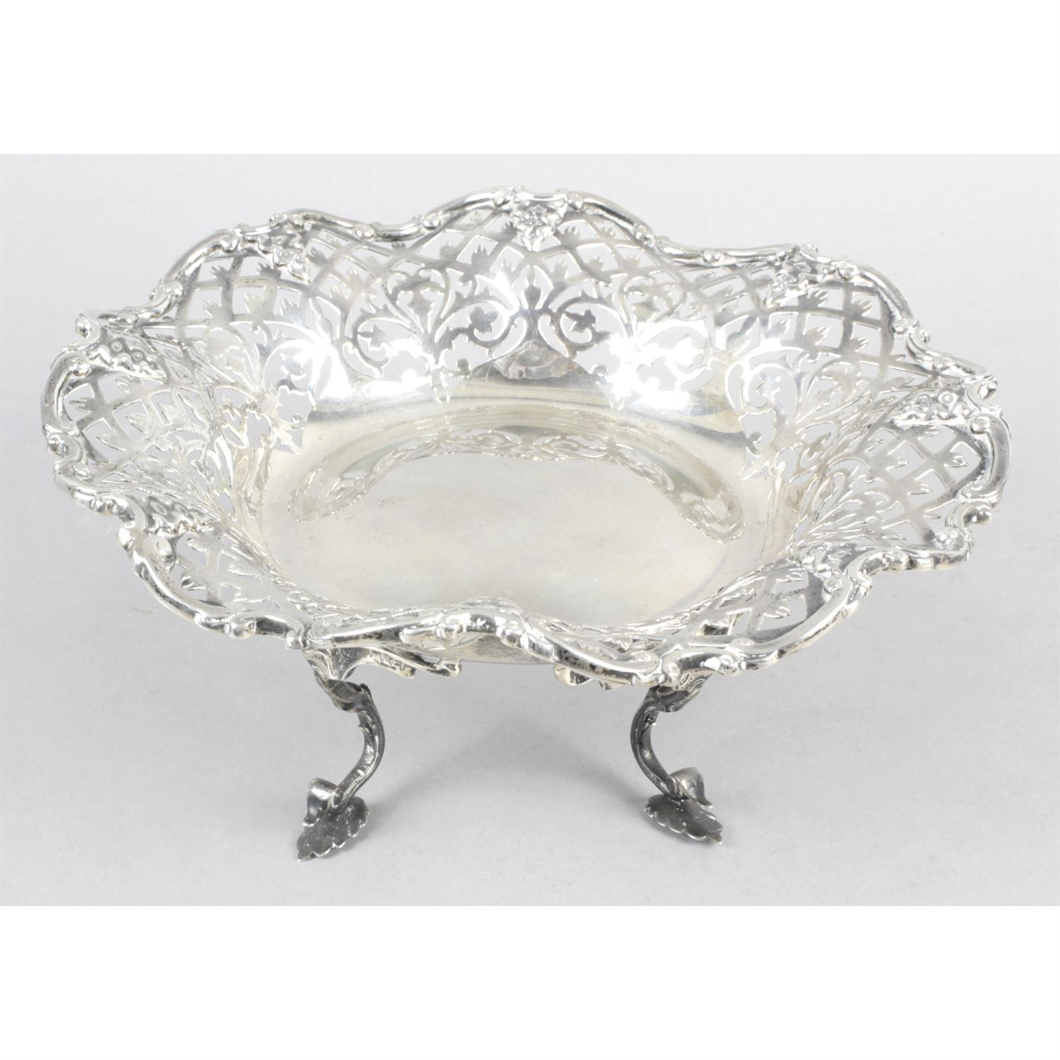 A George V silver pierced dish on scroll feet.