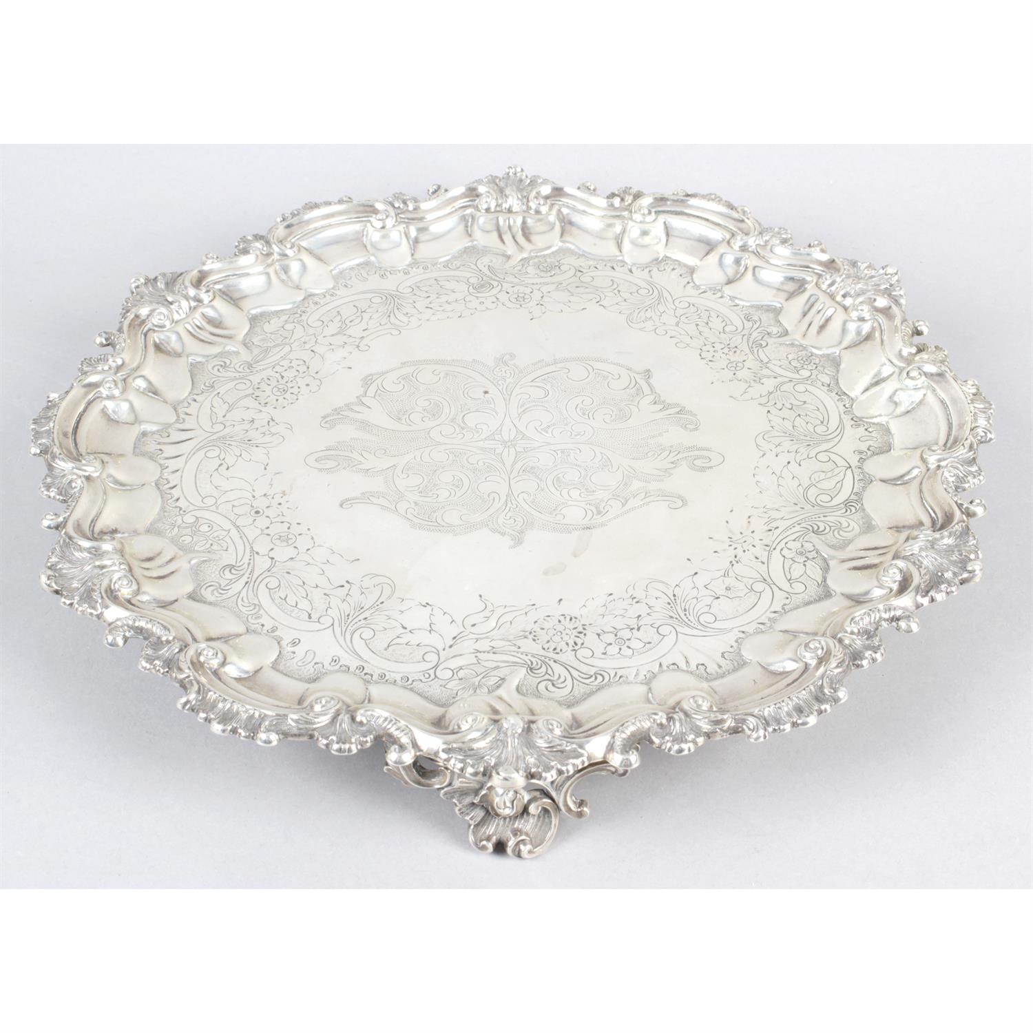 A William IV silver salver with scrolled border.