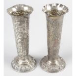 A pair of late Victorian silver embossed vases.