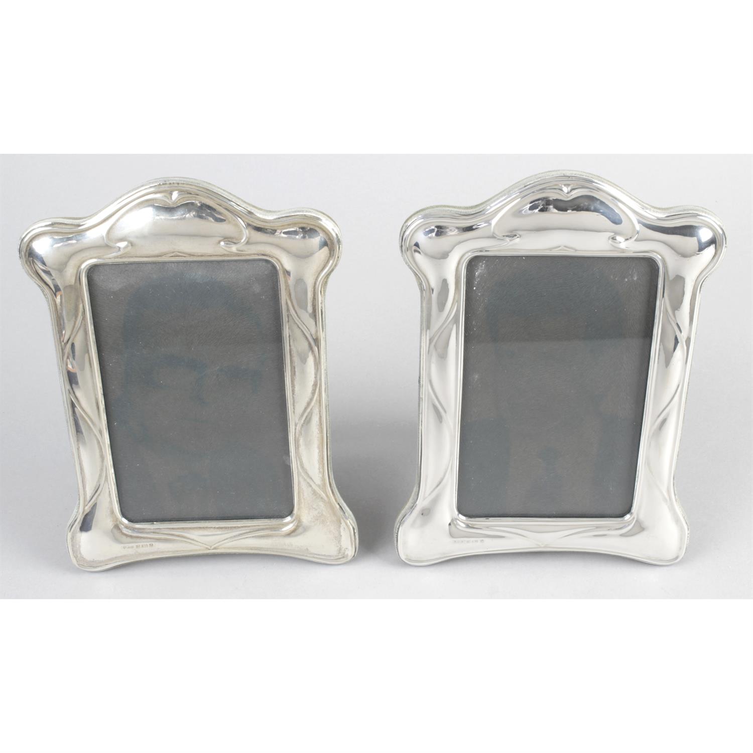 A pair of Art Nouveau style modern silver mounted photograph frames.