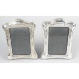 A pair of Art Nouveau style modern silver mounted photograph frames.