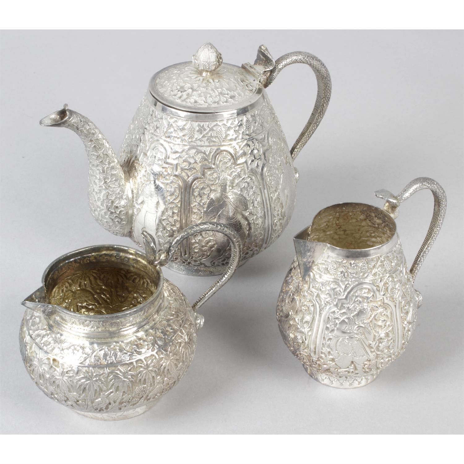 A small teapot and two cream jugs, probably Indian. (3).