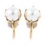 A pair of cultured pearl screwback earrings.