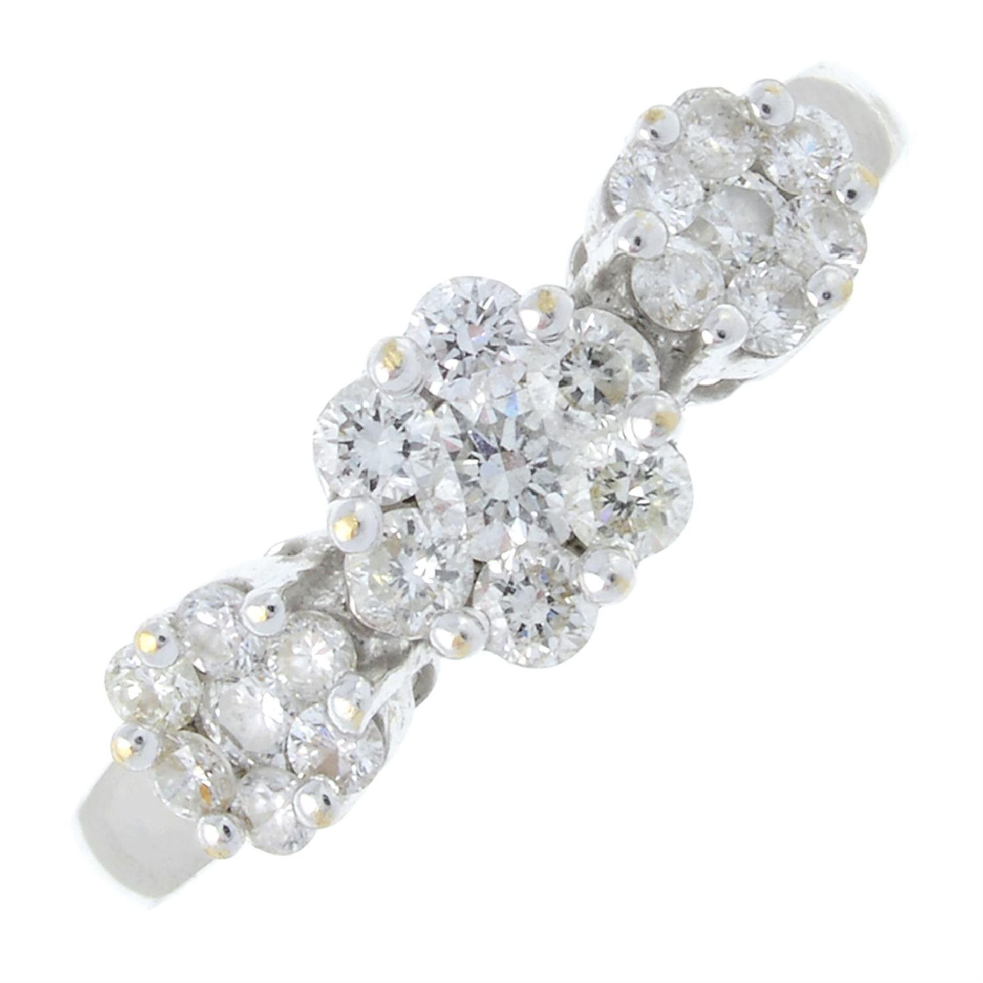 A brilliant-cut diamond triple cluster ring.