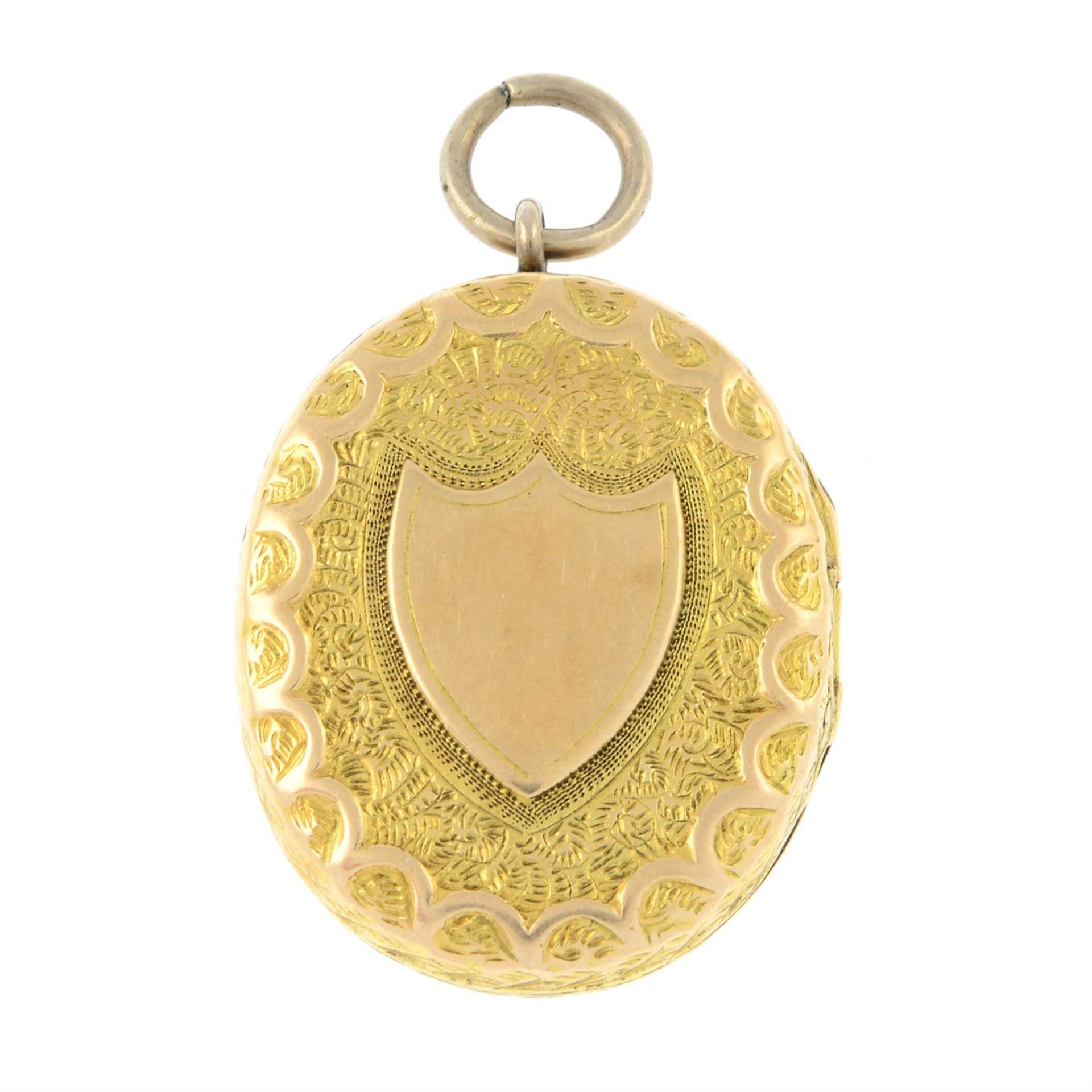 A late Victorian gold locket, with shield crest and cross motif.