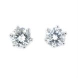 A pair of brilliant-cut diamond stud earrings.