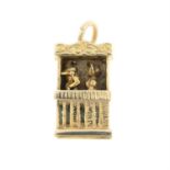 A Punch and Judy pendant / charm.