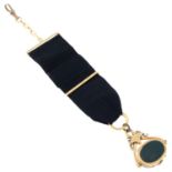 A late 19th century bloodstone and onyx locket fob, suspended from a black fabric watch fob.