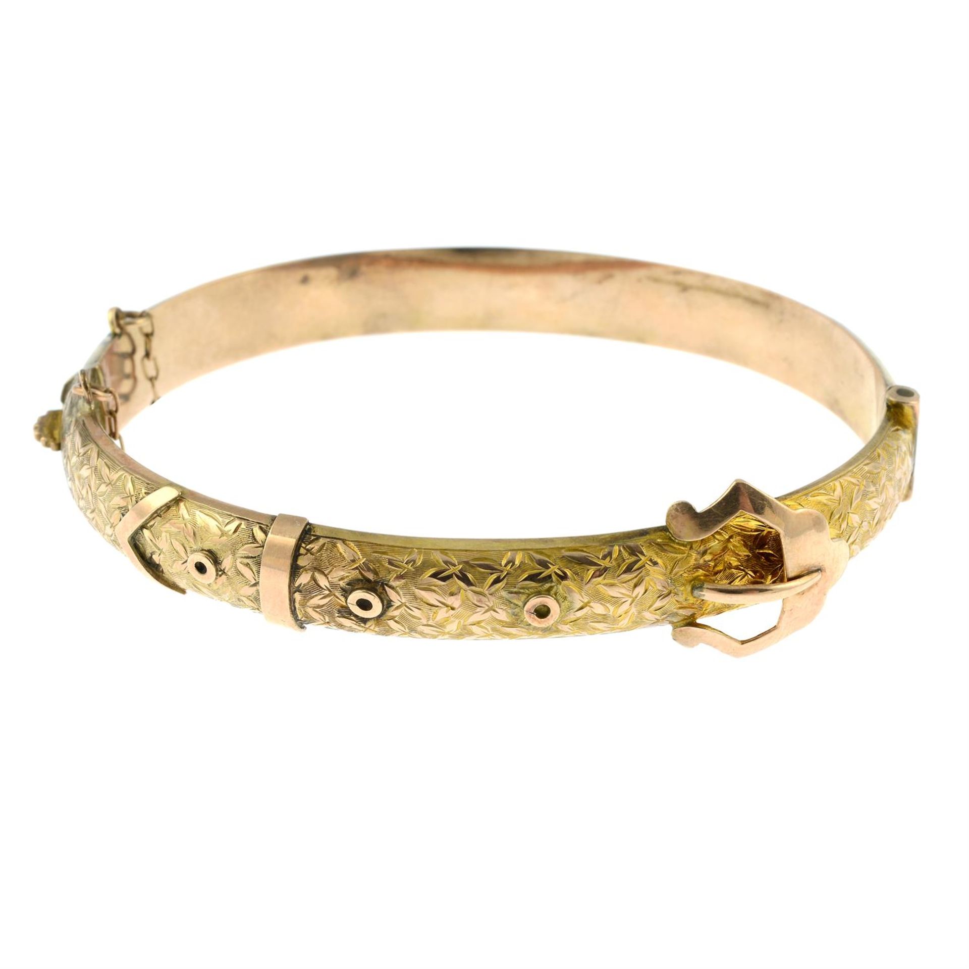 An early 20th century 9ct gold engraved buckle hinged bangle.