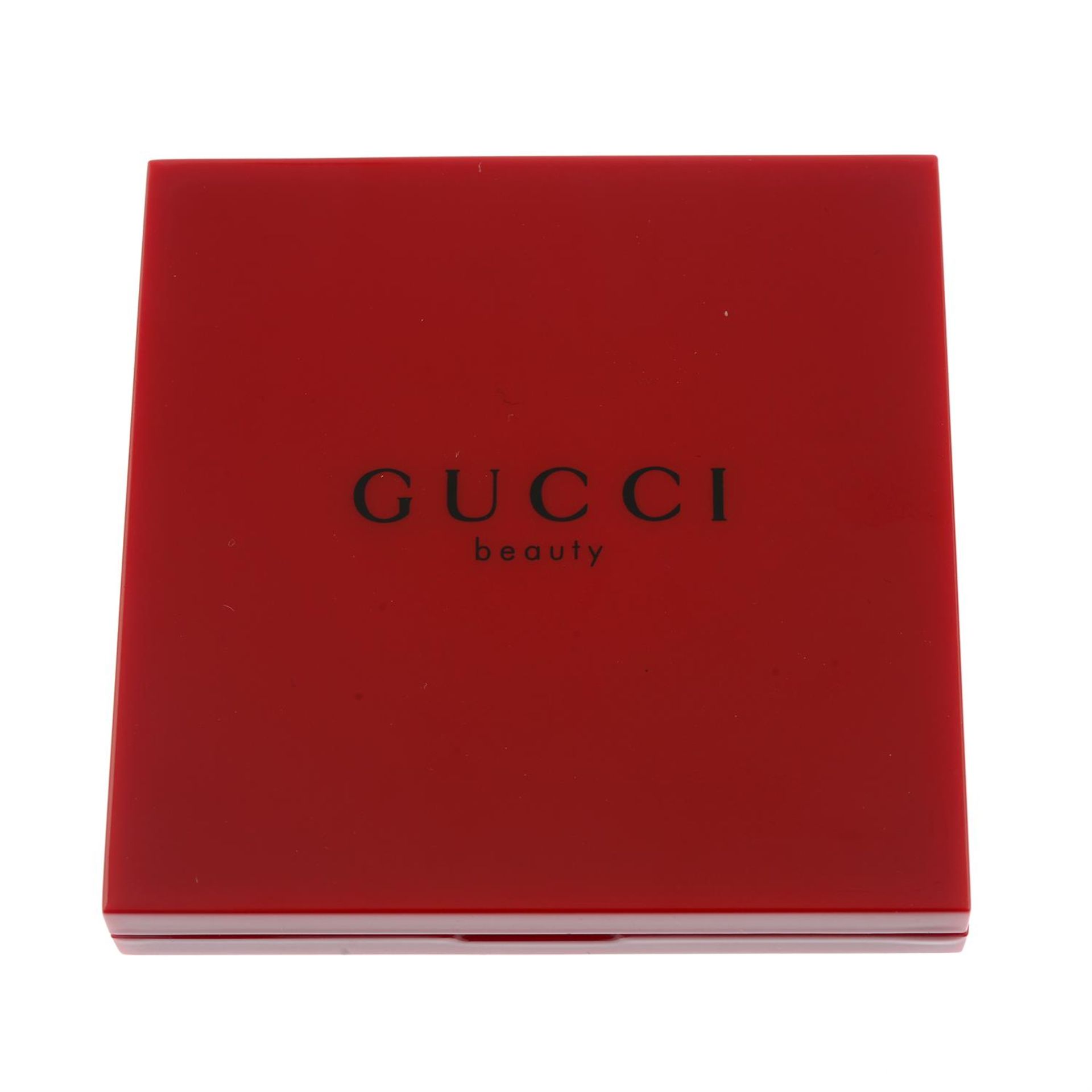 GUCCI - a red compact mirror.