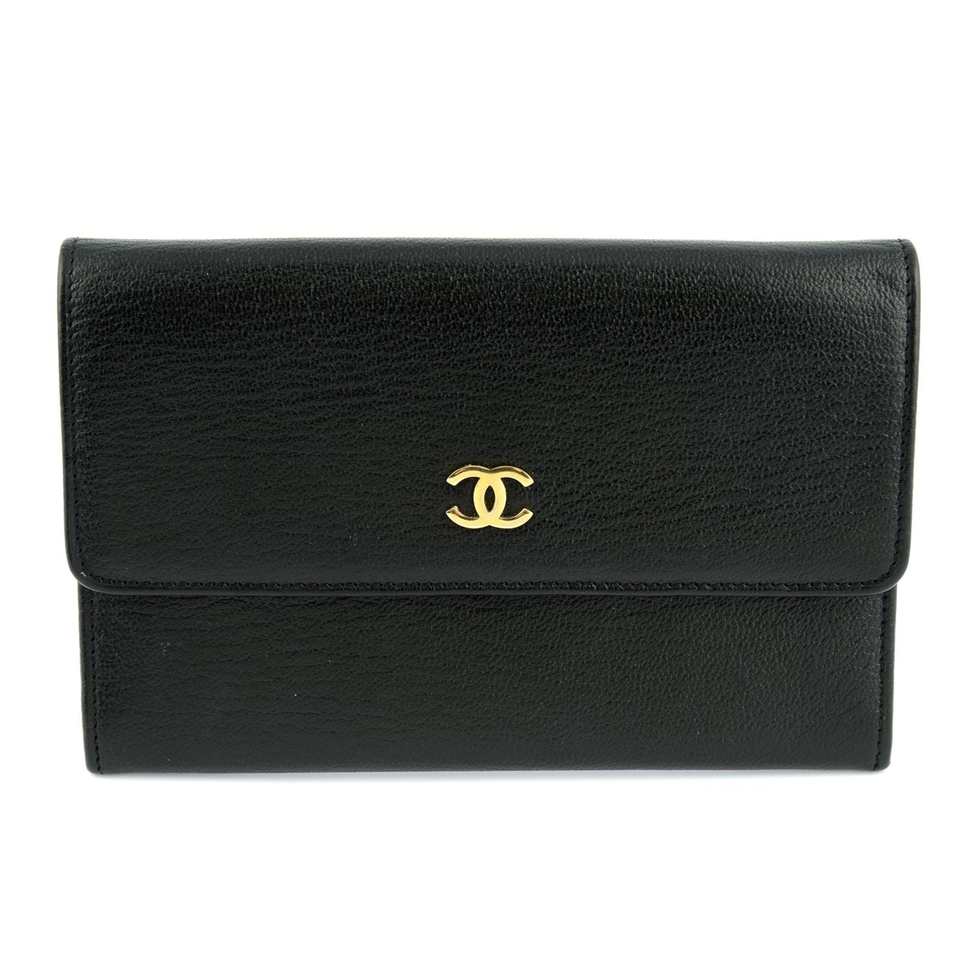 CHANEL - a compact flap wallet.