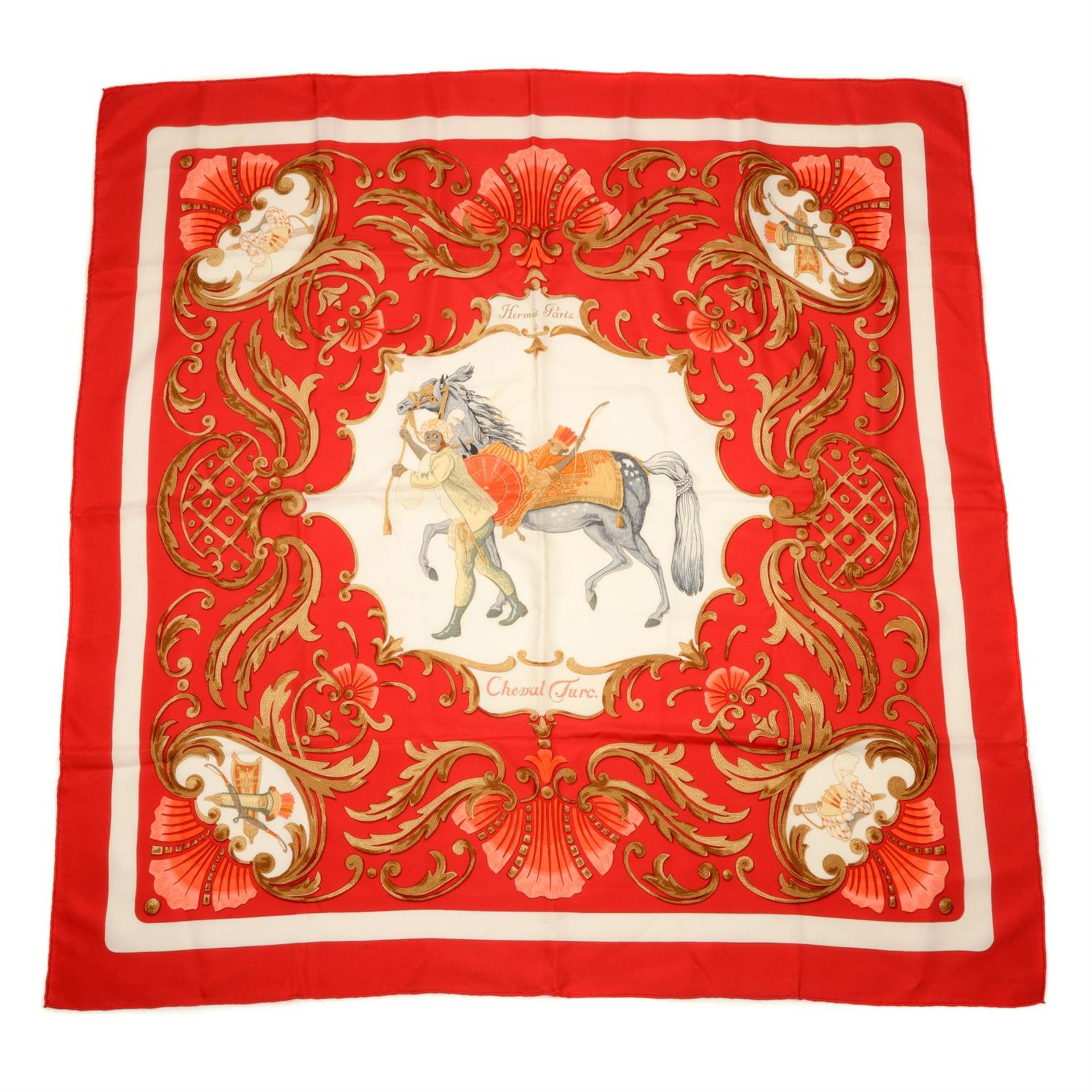 HERMÈS - a red 'Cheval Turc' print silk scarf.