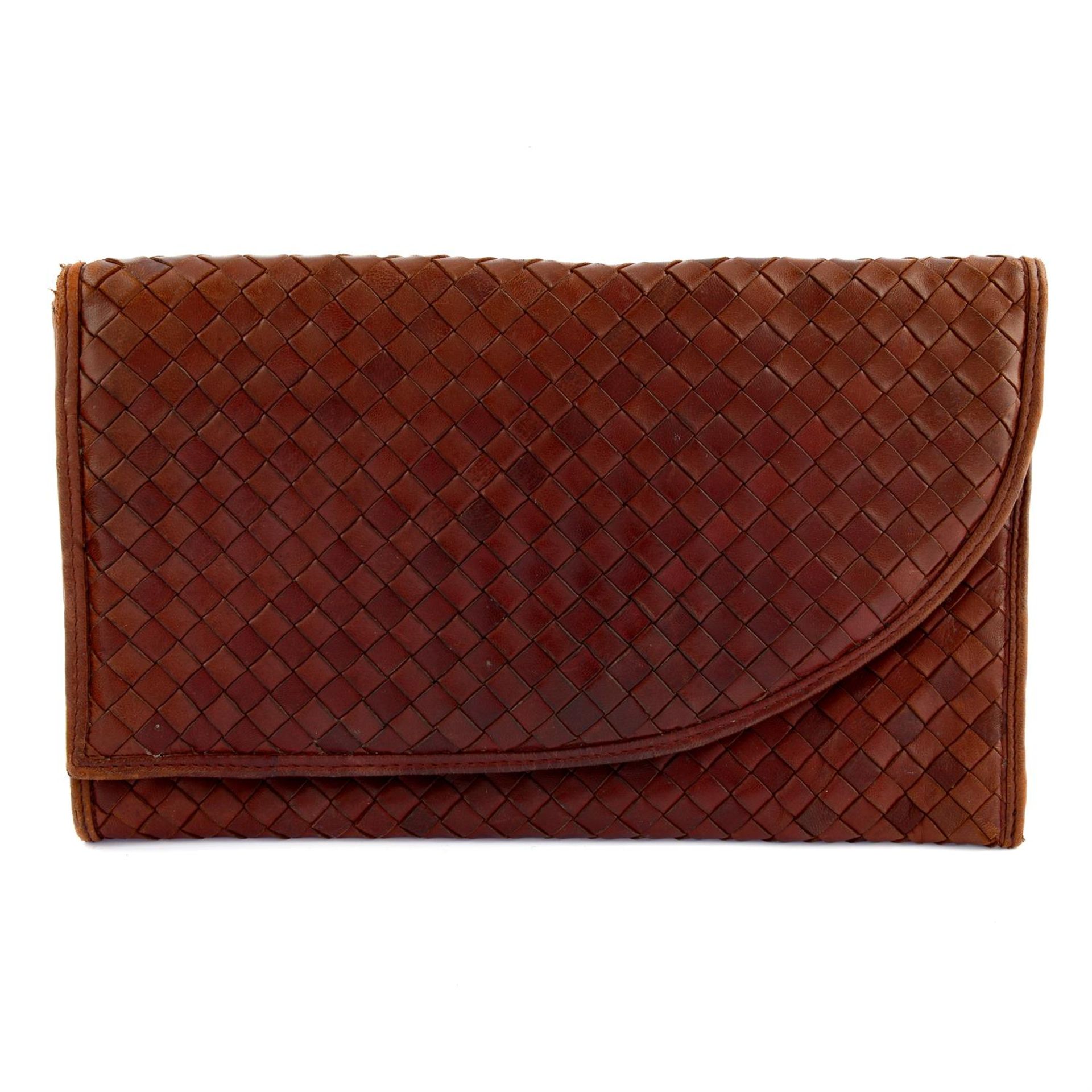 BOTTEGA VENETA - a brown leather clutch bag.