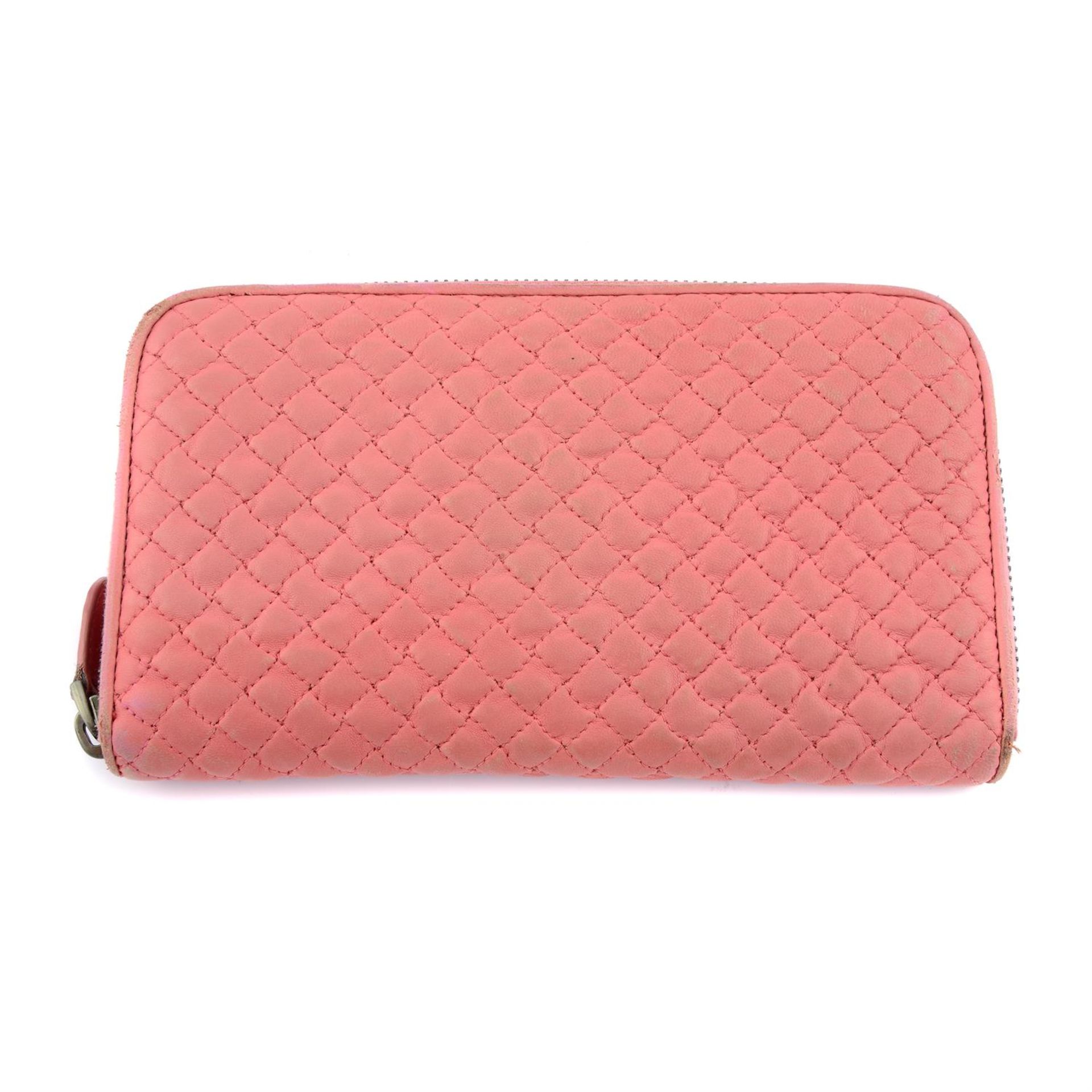 BOTTEGA VENETA - a pink leather wallet.